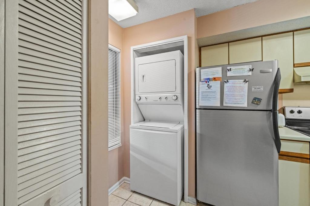 a kitchen with a refrigerator and a washer and dryer at Heron Pointe C8 in Myrtle Beach