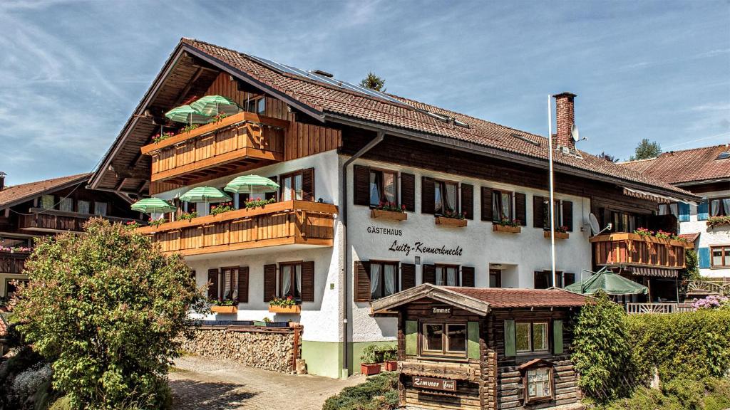 a large building with wooden balconies on top of it at Gästehaus Luitz-Kennerknecht in Fischen