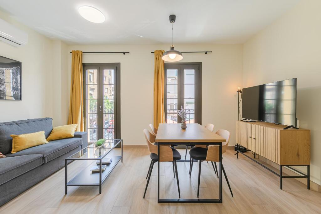 a living room with a couch and a table at Bosco Eco Living in Seville