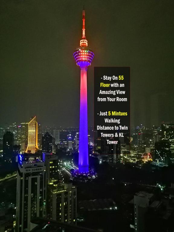 auckland tower lit up in blue and red at night at Yemala Suites at Vortex KLCC in Kuala Lumpur