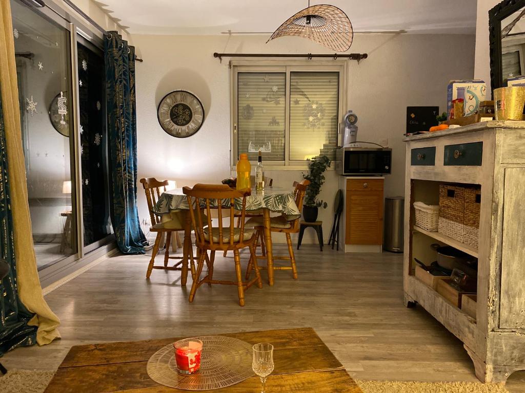a kitchen and dining room with a table and chairs at Refuge St Lary in Saint-Lary-Soulan