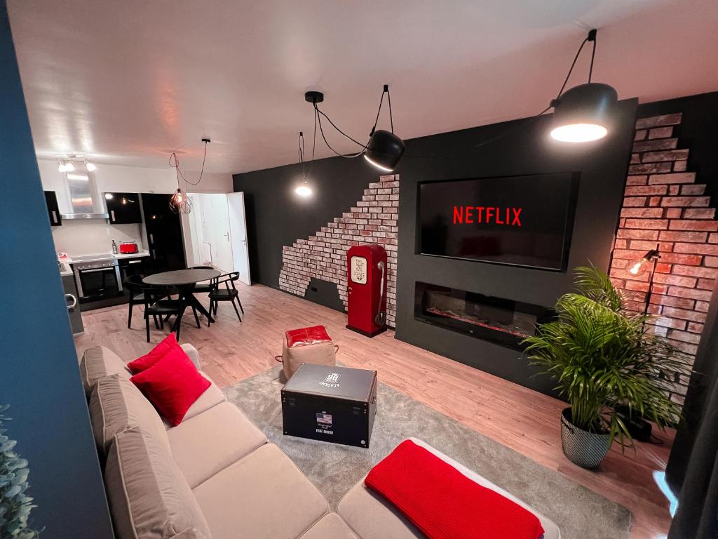 a living room with a white couch and red pillows at Industrial Apartment in Belval the University City in Esch-sur-Alzette