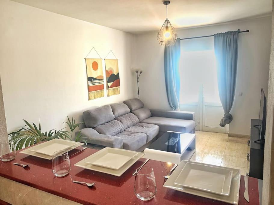 a living room with a couch and a table at A cozy staying in the heart of Lanzarote. in San Bartolomé