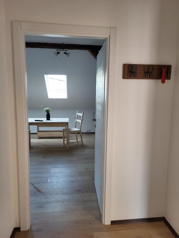 a hallway with a table and a dining room at Apartment By the River in Niš