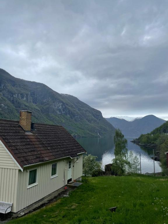 a house with a view of a lake and mountains at Aurland Feriehus in Aurland