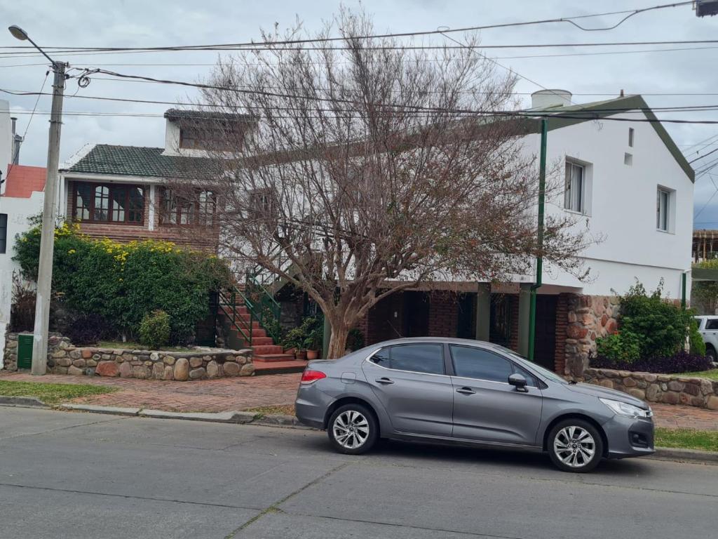 een zilveren auto geparkeerd aan de kant van een straat bij Amelí Alojamiento in Salta