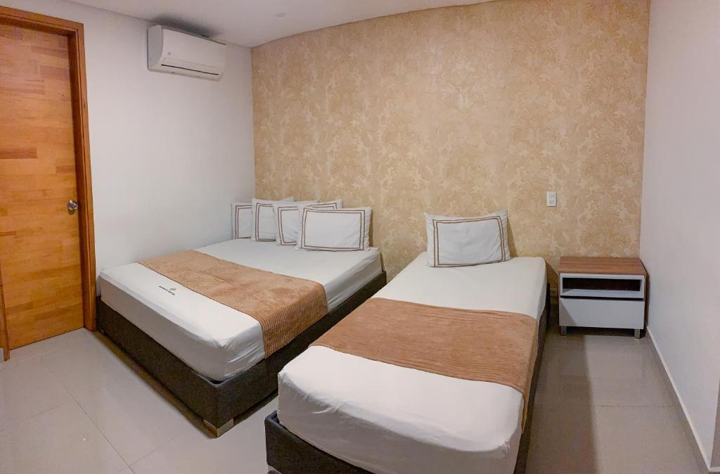 Postel nebo postele na pokoji v ubytování Infinity Hotel