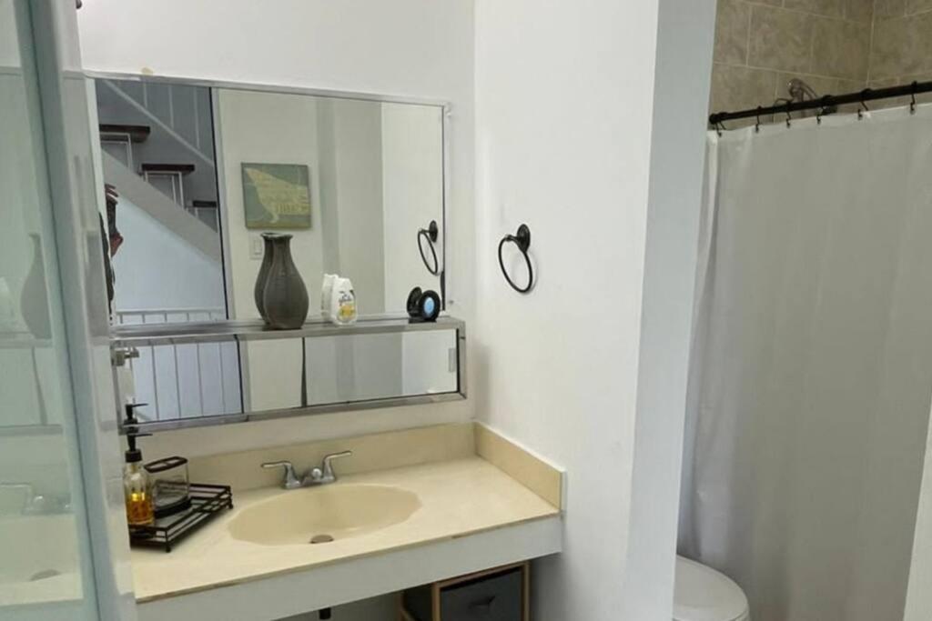 ein Bad mit einem Waschbecken und einem Spiegel in der Unterkunft Peaceful Luxury Villa - TheShine&GlowPlace in Fajardo