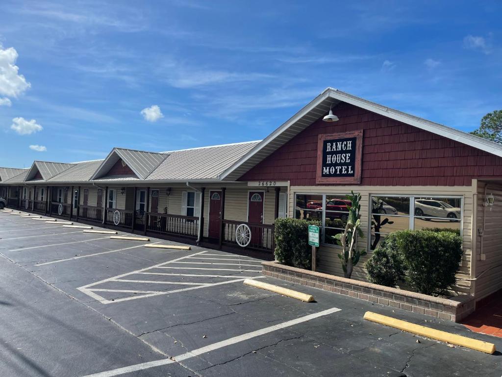 a parking lot in front of a parking house motel at Buffalo Chip's Ranch House Motel in Bonita Springs