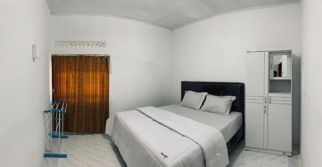 Tempat tidur dalam kamar di Taratak Homestay