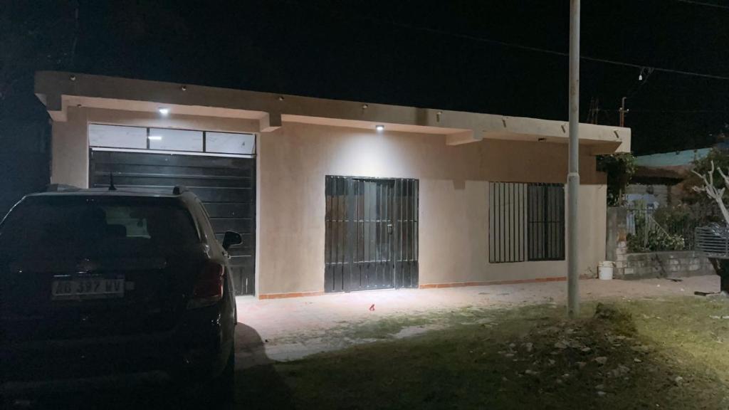 a car parked in front of a house at night at Roli in Clorinda