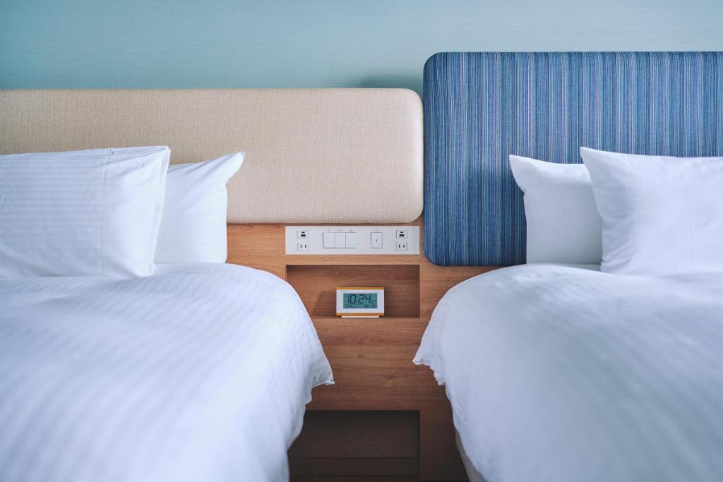 Postel nebo postele na pokoji v ubytování Miyako Hotel Kyoto Hachijo