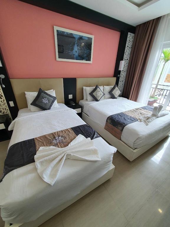 Giường trong phòng chung tại Muine Sports Hotel