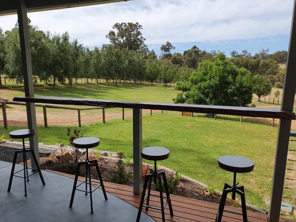a view from the porch of a house with stools at Preston Valley Shed Stay in Lowden
