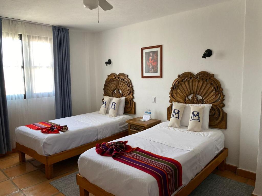 Postel nebo postele na pokoji v ubytování Hotel La Lejona