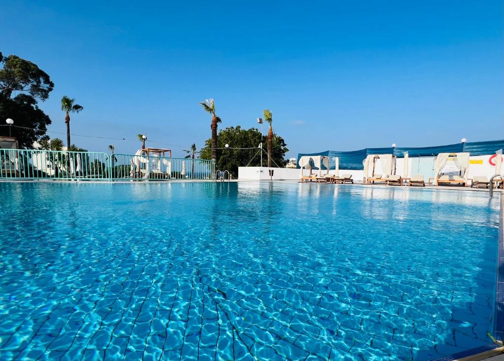 a large swimming pool with blue water at Adelais Bay Hotel in Protaras