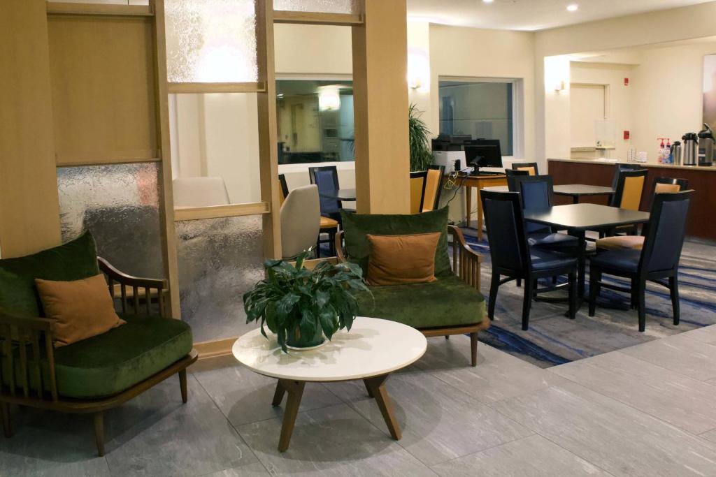 a waiting room with chairs and tables and a table at Fairfield Inn & Suites by Marriott San Francisco San Carlos in San Carlos