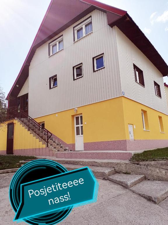 a house with a sign in front of it at Apartment Božica in Žabljak