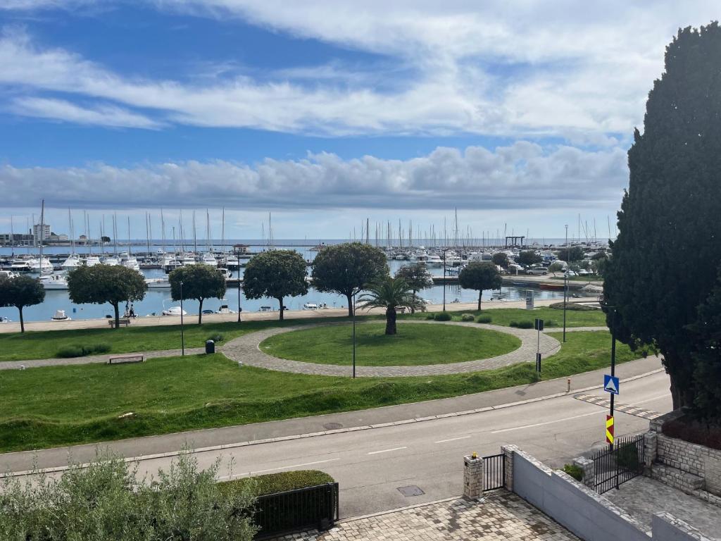 a street with a park with a view of a harbor at App Forza in Umag