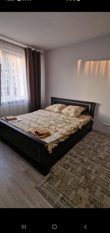 a large bed in a bedroom with a window at Верховина in Uzhhorod