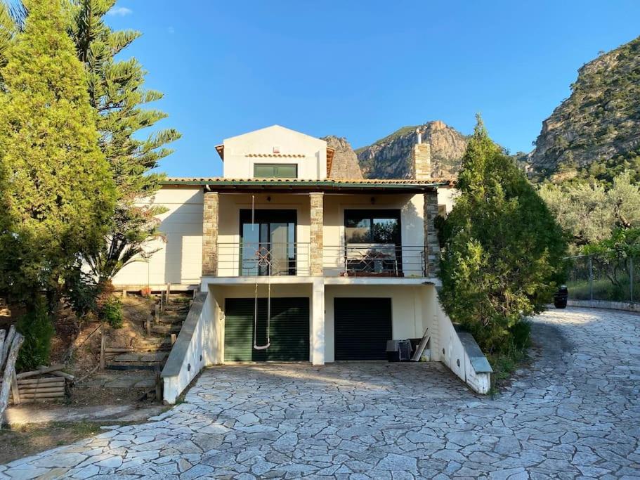 a house sitting on top of a stone driveway at Sens de Dieu - Private luxury in Diakopto