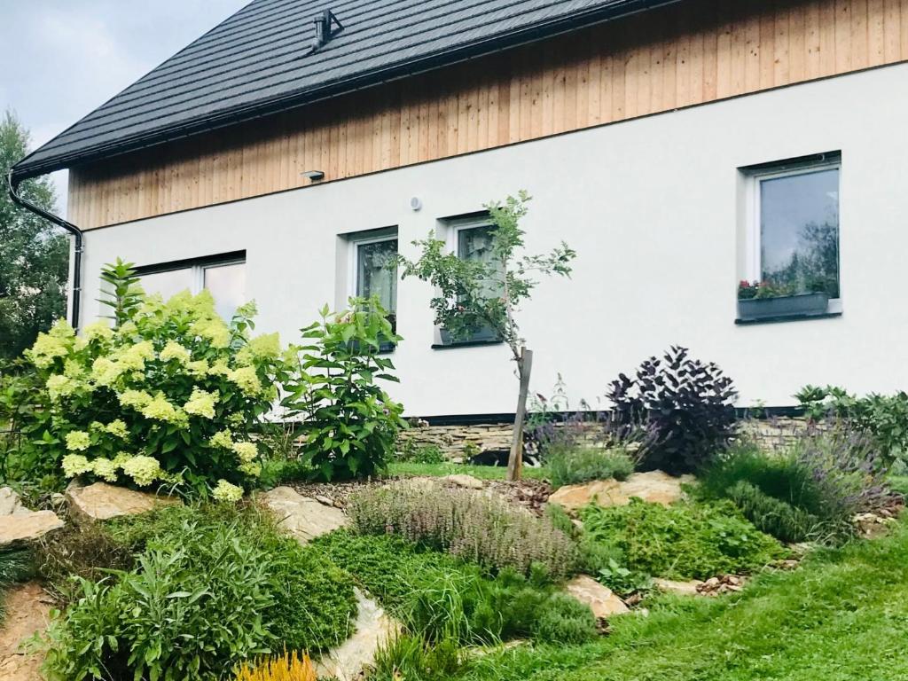 a garden in front of a house at Penzion Kvilda - Luční in Kvilda