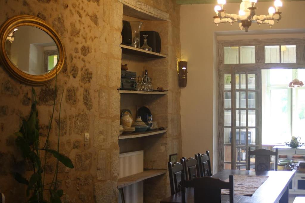 a dining room with a mirror and a table and chairs at Bella Vista in Aubeterre-sur-Dronne