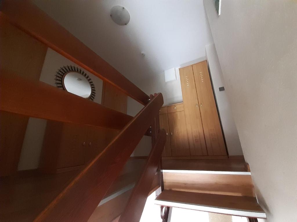 a staircase with a round mirror and a door at Bed and Breakfast 2 in Korswandt