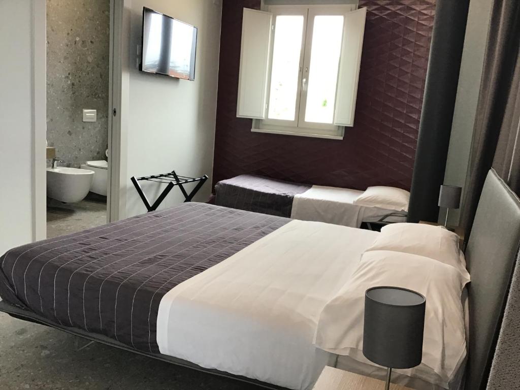 Postel nebo postele na pokoji v ubytování VILLA ACTEA