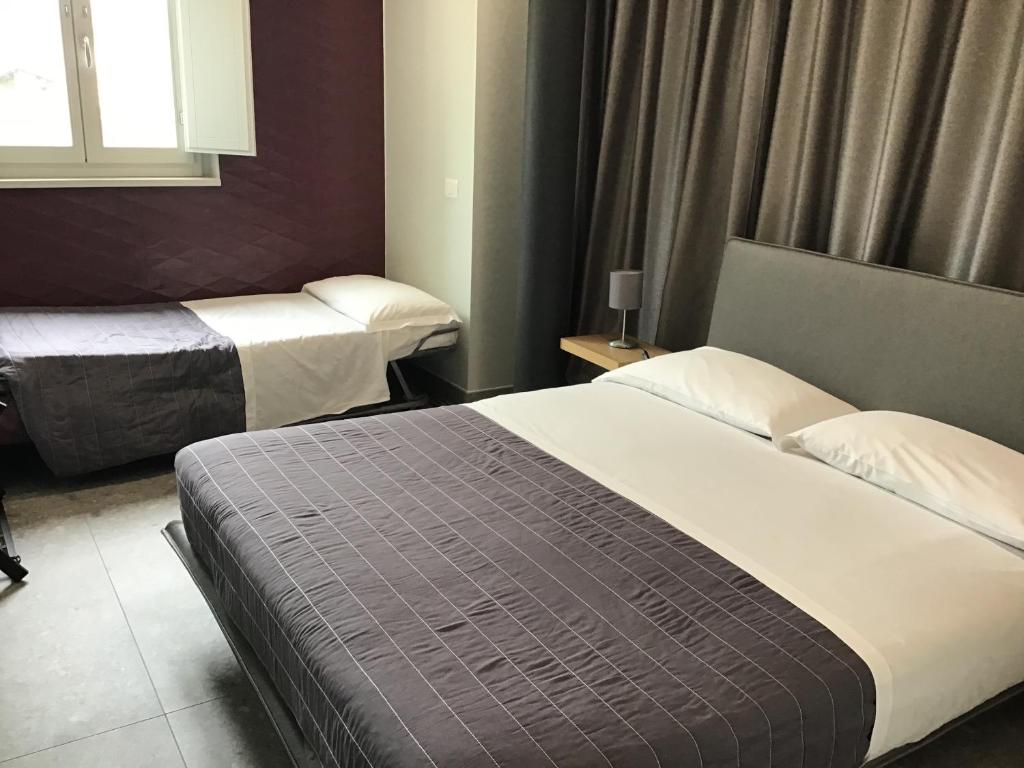 Postel nebo postele na pokoji v ubytování VILLA ACTEA