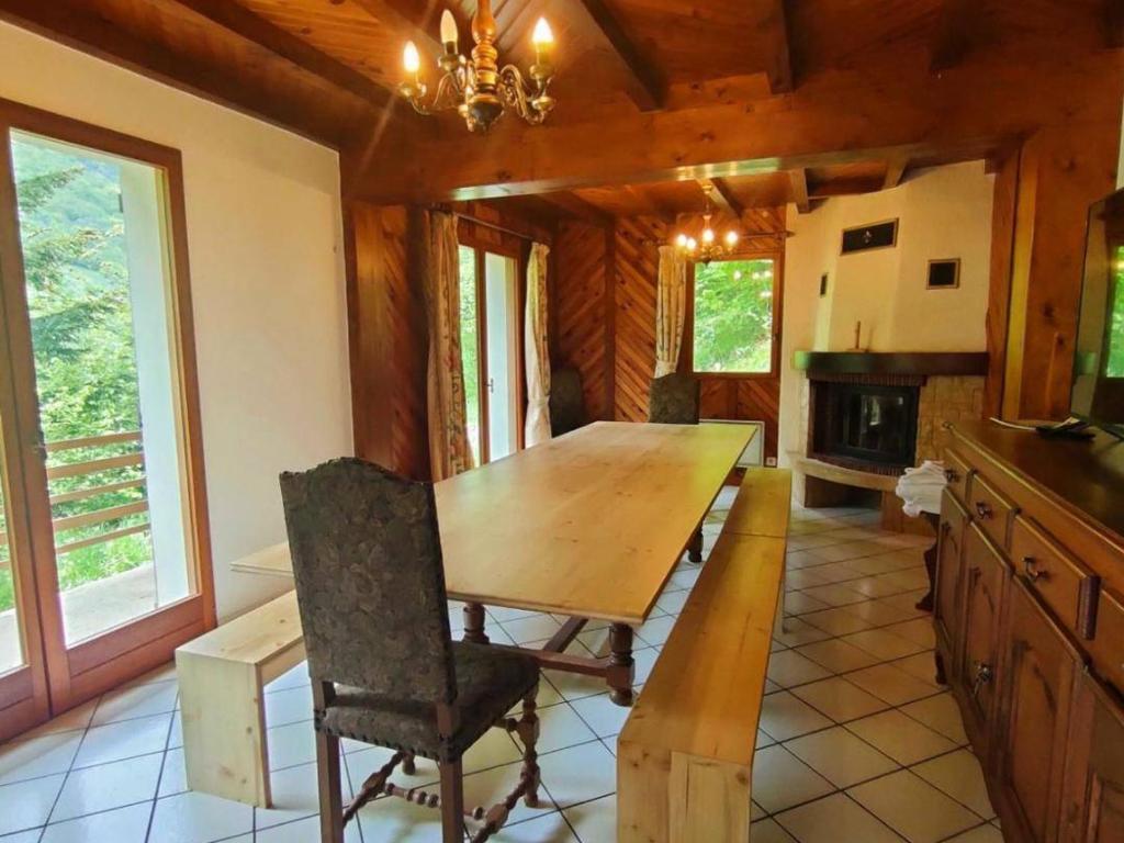 a dining room with a wooden table in a cabin at Maison Cauterets, 9 pièces, 15 personnes - FR-1-234-244 in Cauterets