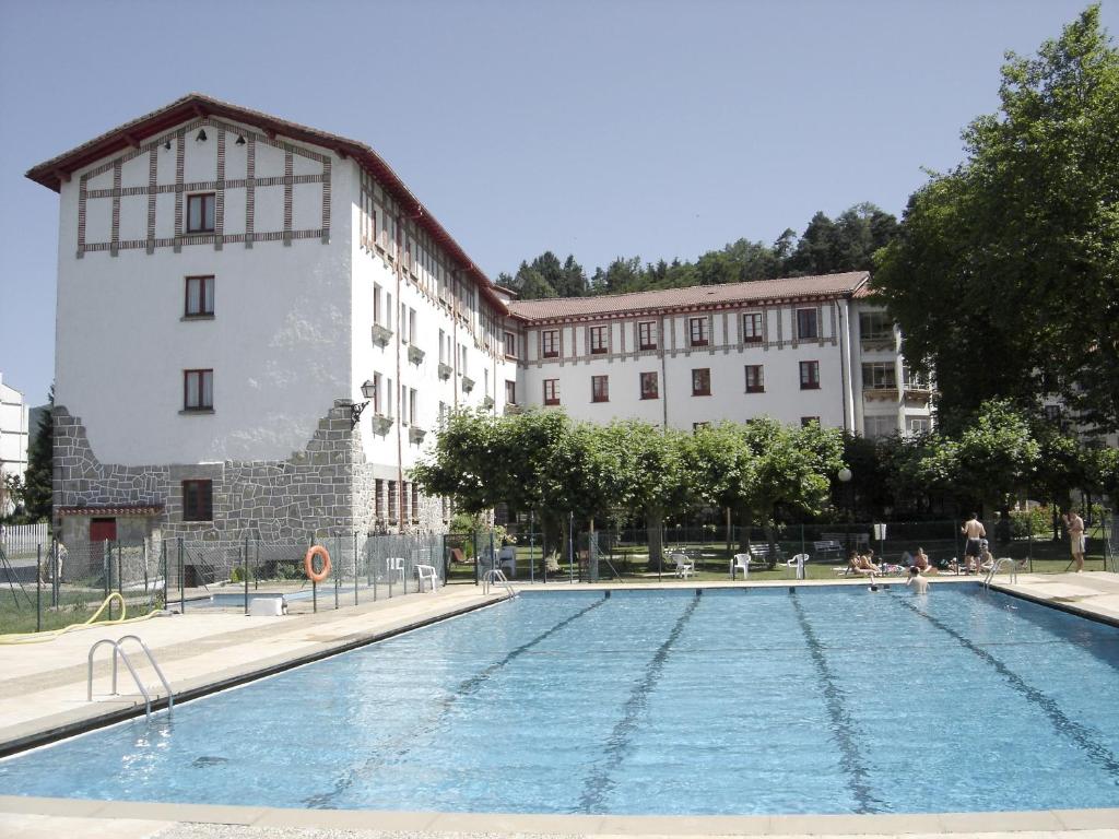 a large swimming pool in front of a building at Hostal Ayestaran I in Lekunberri