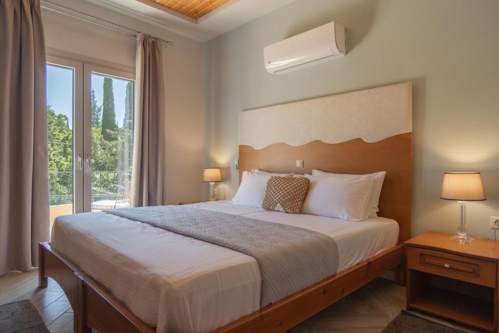 Postel nebo postele na pokoji v ubytování Aris Apartments