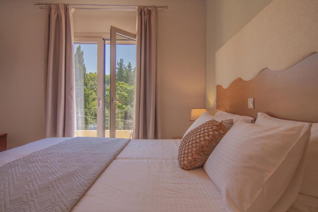 Postel nebo postele na pokoji v ubytování Aris Apartments