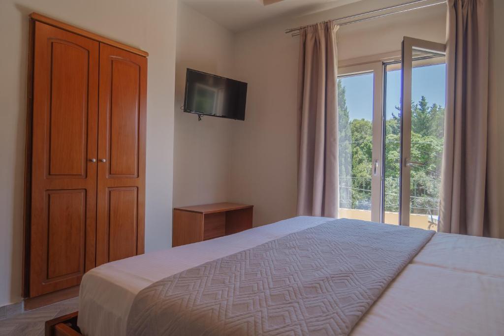 Postel nebo postele na pokoji v ubytování Aris Apartments