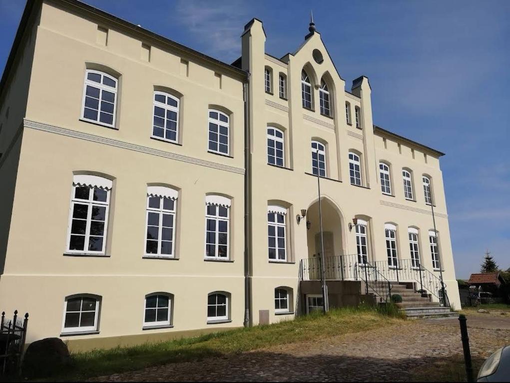 a large white building with a lot of windows at Schloss Altenhagen in Kröpelin