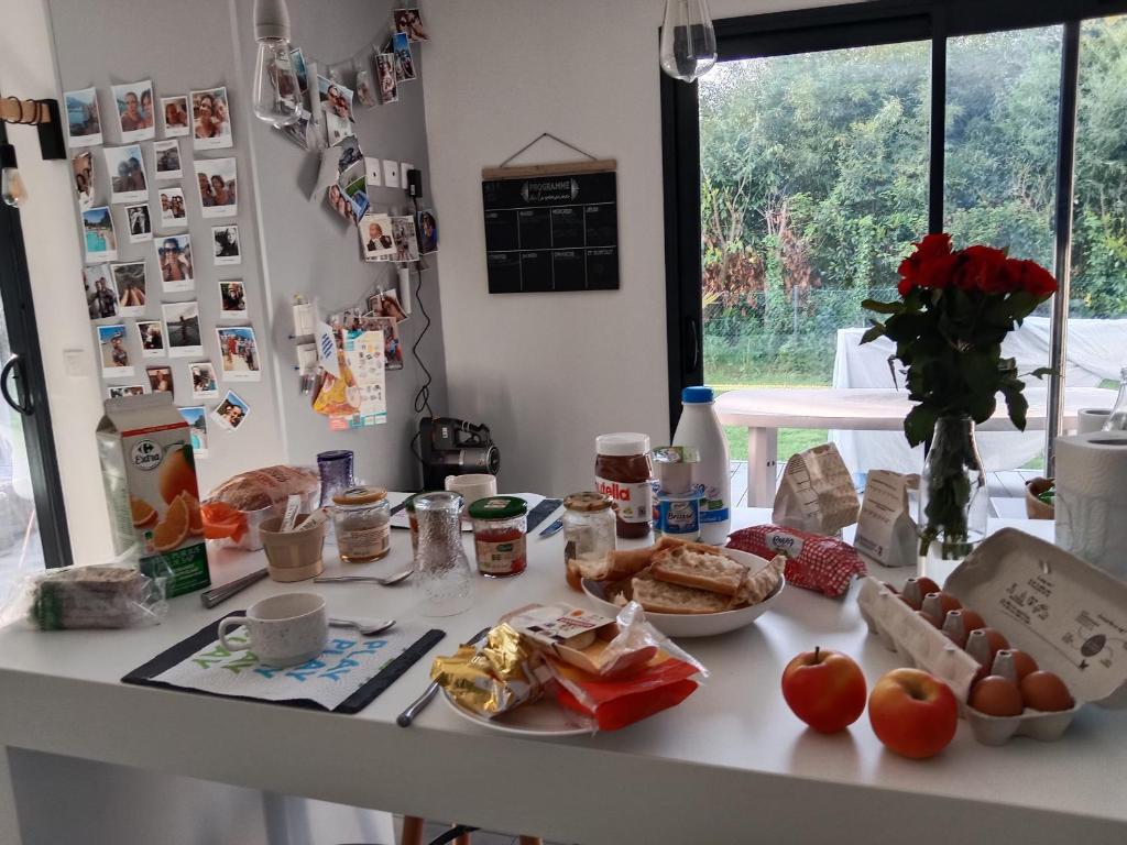 a table with breakfast foods on it in a kitchen at Maison architecte in Romilly-sur-Andelle