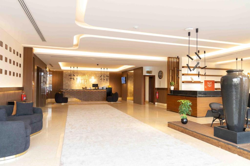 a lobby of a hotel with couches and a bar at شقق بانسيه المخدومة in Riyadh