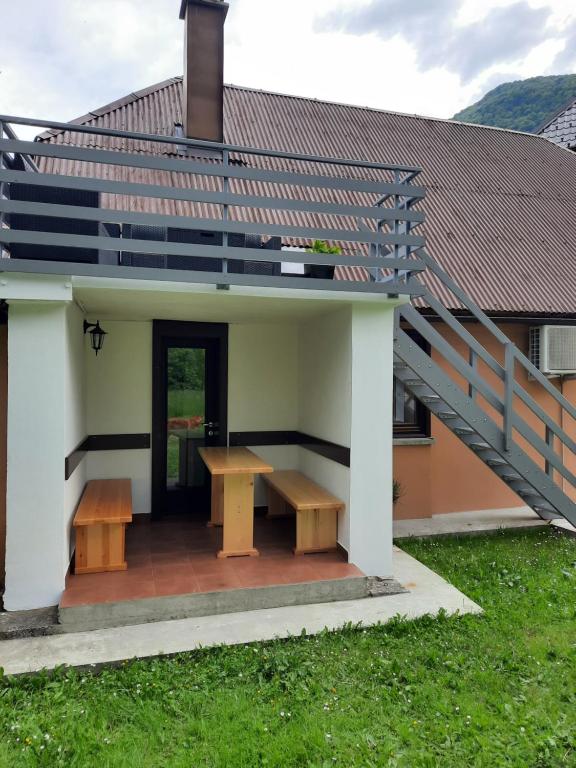 a house with a table and a staircase on it at APARTMA BENY with SAUNA in Žaga