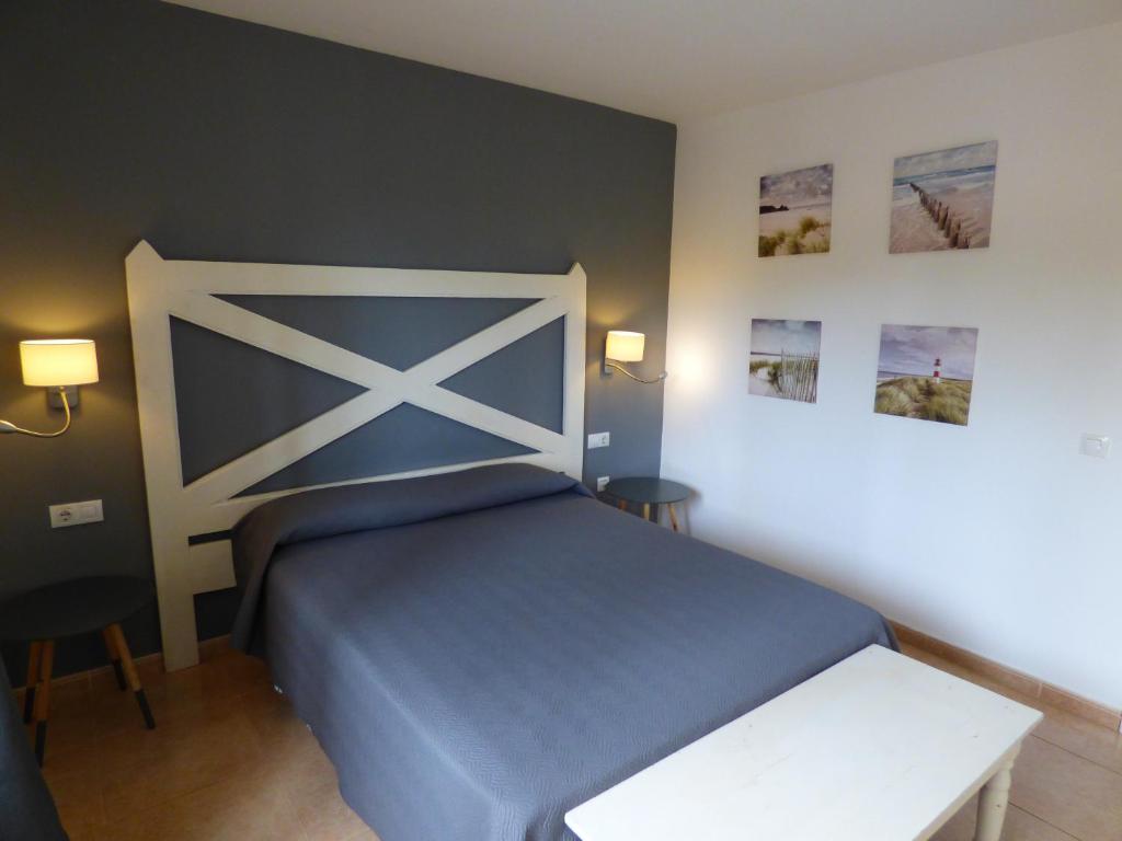 a bedroom with a blue bed and two chairs at Casa Julia - OASIS PAPAGAYO in Corralejo