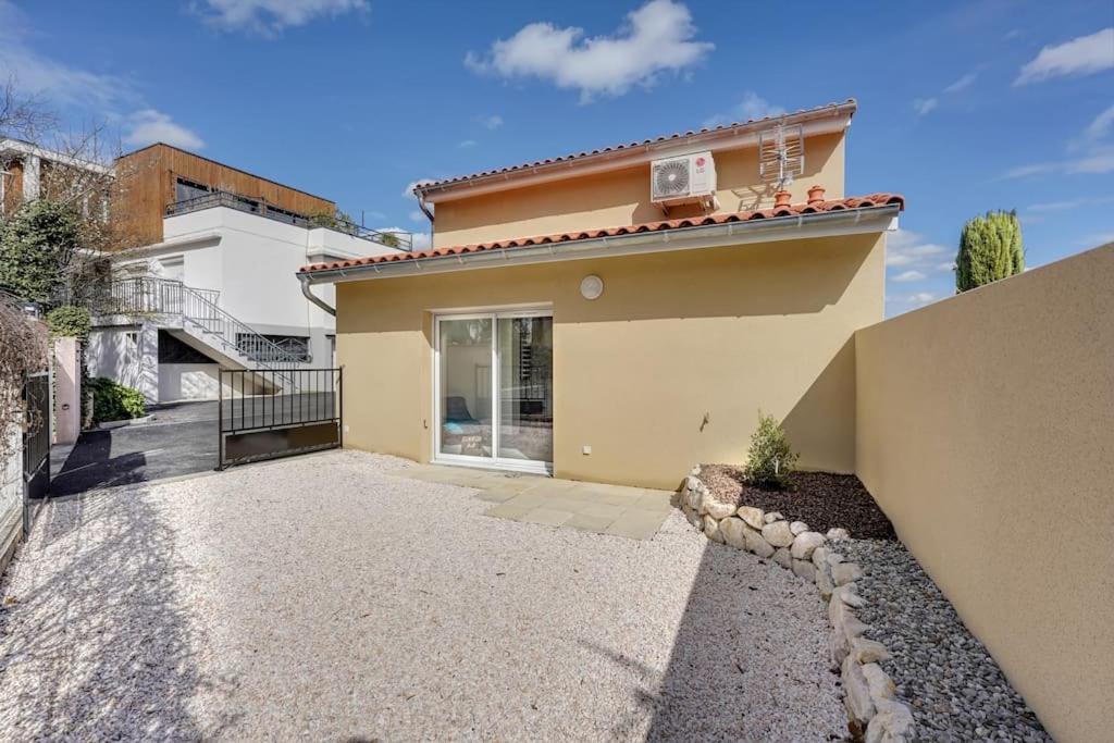 a house with a walkway in front of it at LA MEDITERRANEENNE in Quint-Fonsegrives