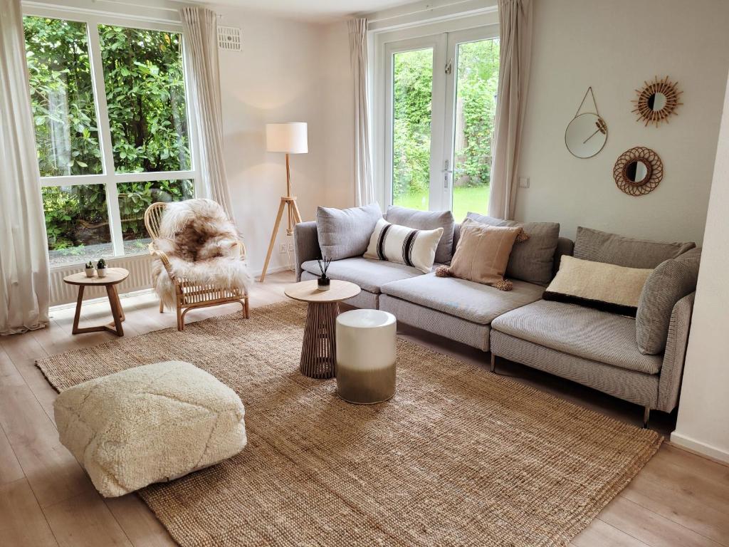 ein Wohnzimmer mit einem Sofa und einem Stuhl in der Unterkunft Scandinavian Wellness met hottub & sauna in Ewijk