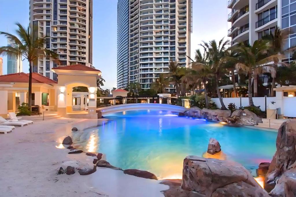 a swimming pool at a resort with tall buildings at Iconic Chevron Renaissance Private Apartments in Gold Coast