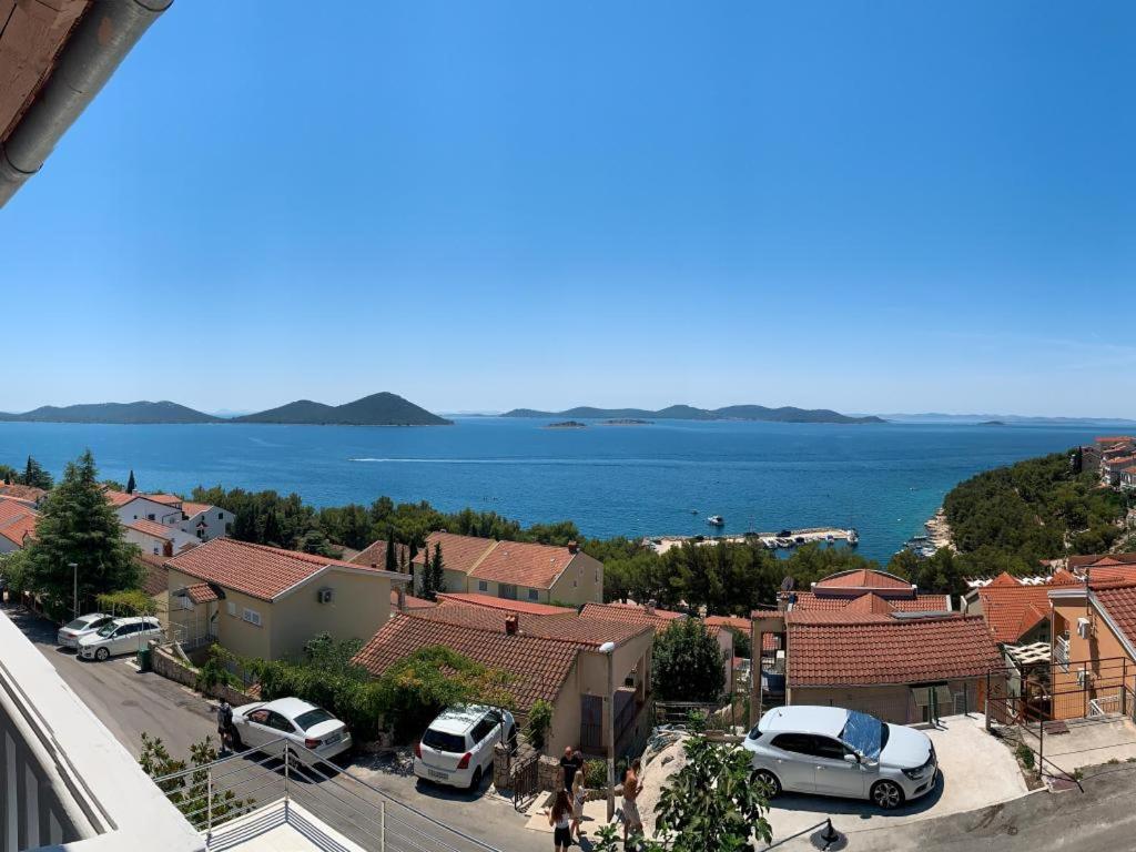a view of a town with the ocean in the background at Apartman Bella in Drage