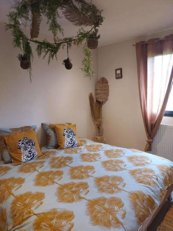 a bedroom with a large bed with a floral bedspread at chez Gaby 