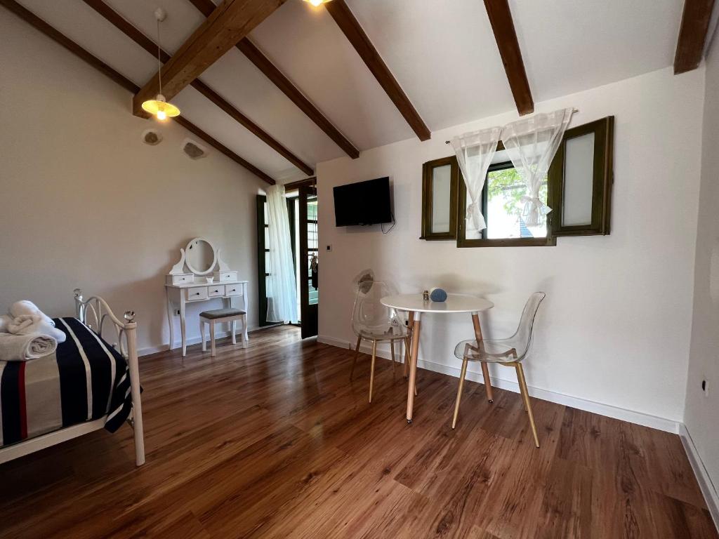 a bedroom with a table and chairs in a room at Gaya apartments in Šibenik