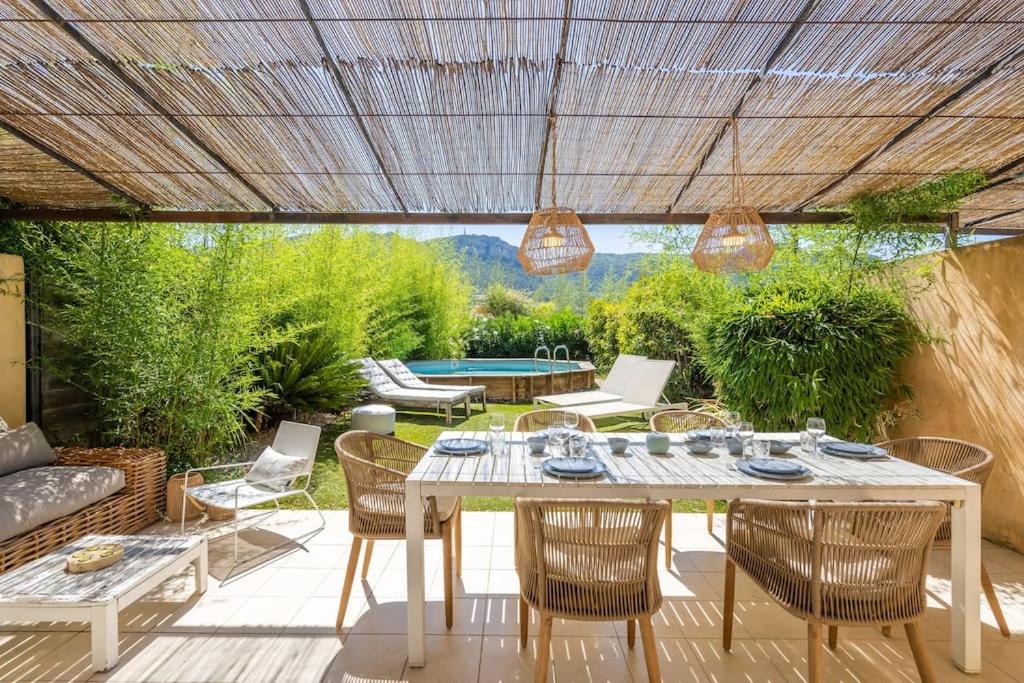 un patio con mesa, sillas y piscina en Just in Cap Canaille, en Cassis