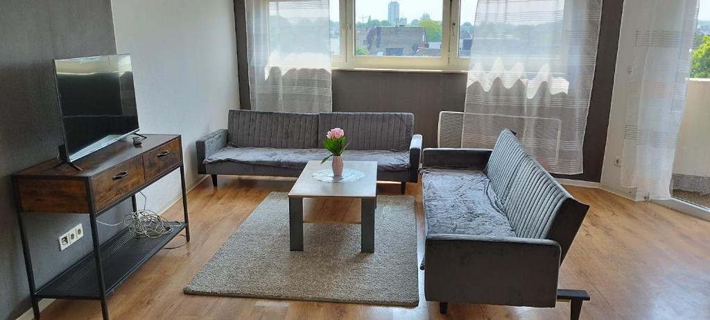 a living room with a couch and a table at Schöne sonnige Wohnung in Jüchen