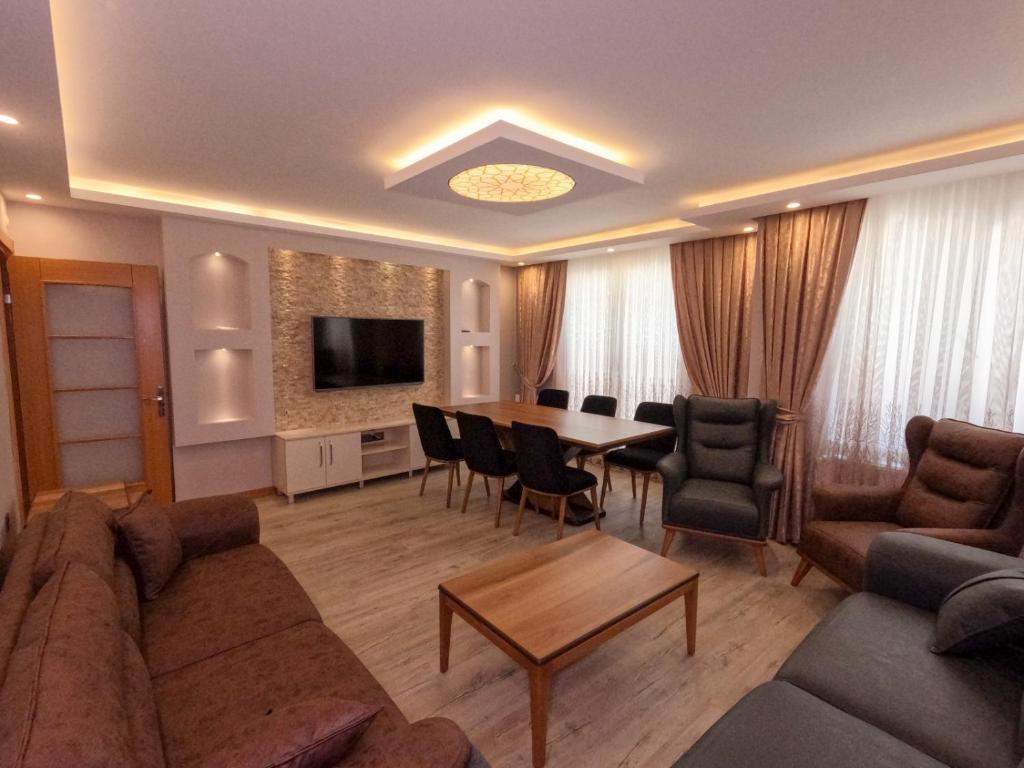 a living room with a couch and a table and chairs at Big Historia Apartment in Istanbul