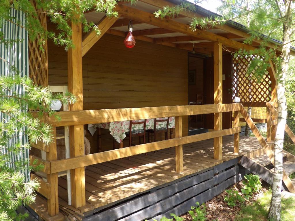 a wooden porch of a house with a fence at Agroturystyka u Wioli i Irka , domek u Ireny, spływy kajakowe in Karsin